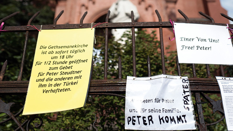 Aushänge für den in der Türkei inhaftierten Berliner hängen vor Beginn einer Fürbitten-Andacht für Steudtner am 31.07.2017 vor der Gethsemanekirche in Berlin