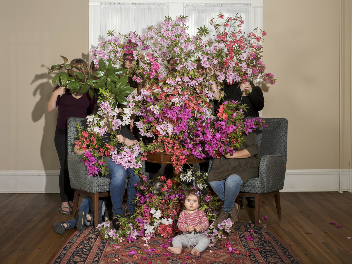 Portalfoto März, Gruppenbild, Personen hinter Blütenzweigen 