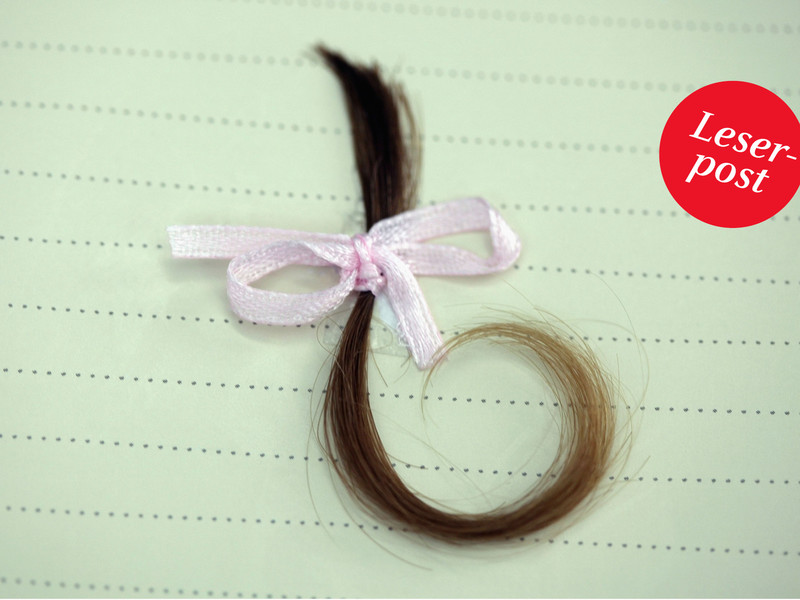 Haarsträhne mit Schleife auf einem Blatt Papier: Bewegender Fund: Ihr Vater hatte eine Locke ihres Haars aufbewahrt