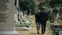 Trauernde Eltern auf dem Friedhof