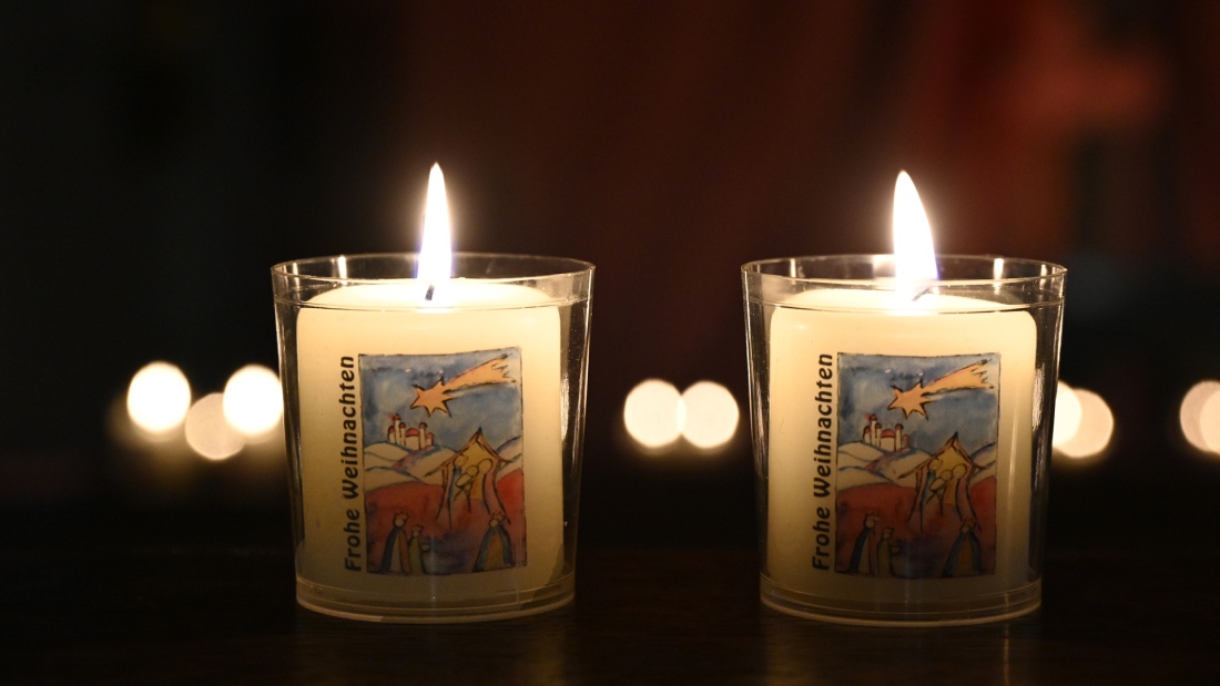 Zwei Kerzen im Glas erhellen die Dunkelheit
