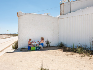 Valencia, Spain, August 23, 2010 A couple is having a picnic in a narrow stretch of shadow along the Mediterranean coast. That day the temperature reaches 44 degrees Celsius. From the series  Mediterranean