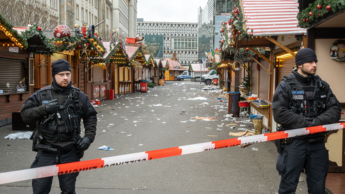 Polizisten stehen am Weihnachtsmarkt in Magdeburg