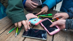 Schüler mit Smartphones auf dem Schulhof.