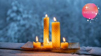 Bienenwachskerzen in winterlicher Landschaft