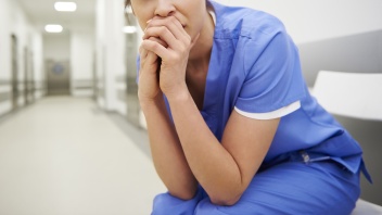 besorgte Ärztin sitzt in Krankenhausflur