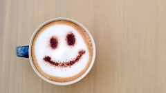 Tasse Kaffe mit Milchschaum und Smiley
